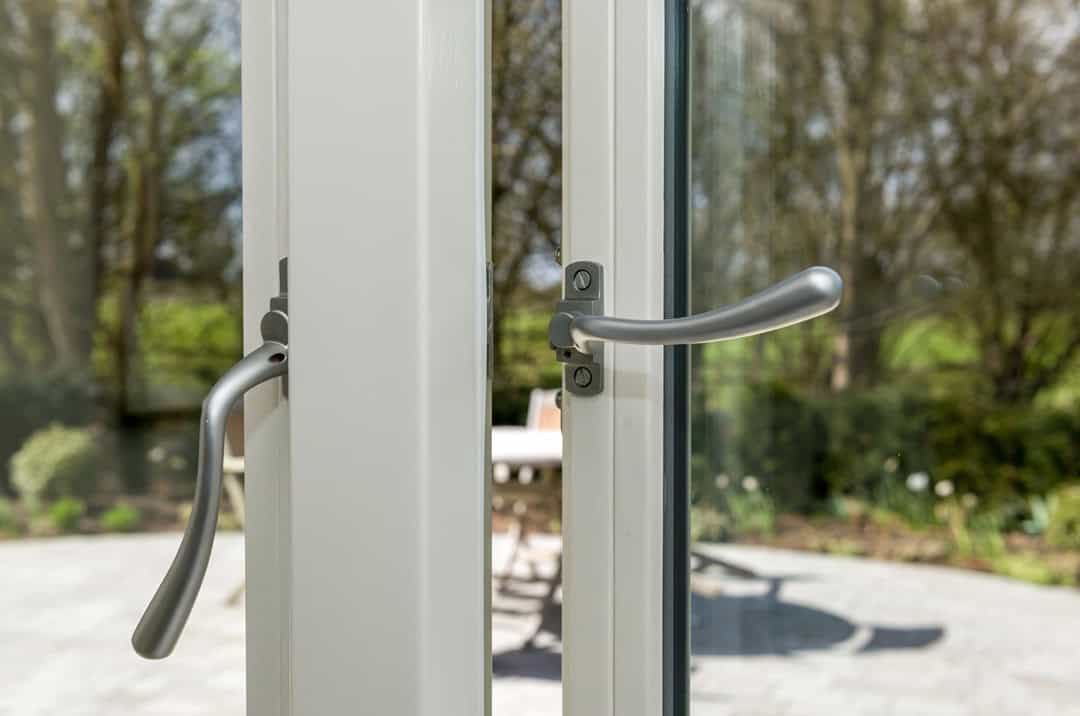 Polished chrome handles on timber casement window