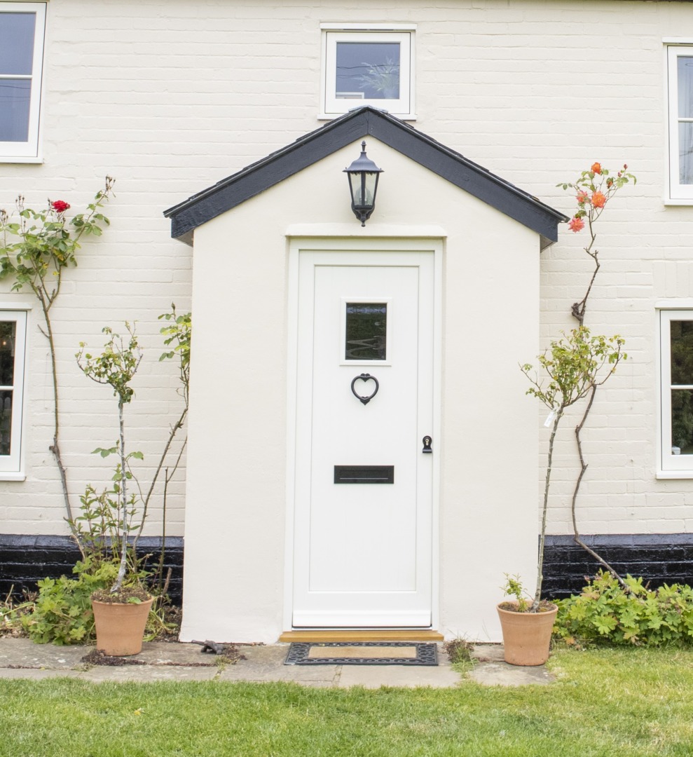 timber front door painted cream with black hardware 